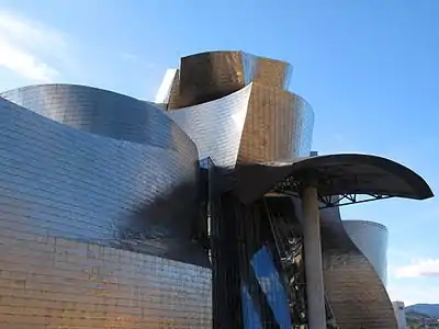 Guggenheim Museum Bilbao – designed by Frank Gehry, the walls of this acclaimed building undulate in random curves.