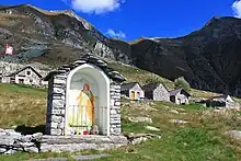 Image 34An "Alp" refers to a high elevation pasture frequented only in summer. It often includes several huts and small places of worship (here the Alpe Bardughè in Ticino). (from Alps)