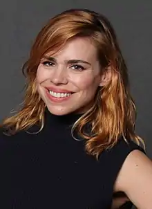 A woman wearing a purple scarf and smiling