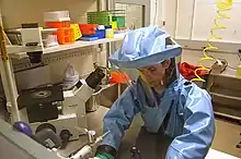 A BSL-4 laboratorian working in an ILC Dover Chemturion "Blue Suit".