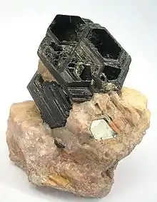 Image 19Perfect basal cleavage as seen in biotite (black), and good cleavage seen in the matrix (pink orthoclase). (from Mineral)