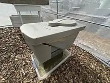 Black soldier fly larvae (BSF) as raised in this container.  As they mature the grubs climb up and fall into the harvest bucket.  BSF are a protein and fat rich food source for chickens, fish and wild birds.  BSF can be fed coffee grounds, food scraps / waste, and even manure.  BSF are a sustainable insect feedstock.