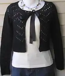 Black open-front cropped knit cardigan with a ribbon tie at the neck