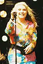 Debbie Harry holding a standing microphone