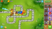 An in-game screenshot of several different monkeys attacking the Bloons and supporting each other.