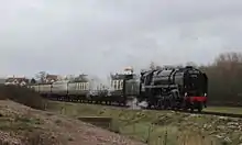 Image 5A steam locomotive and carriages, on the West Somerset Railway, a heritage line of notable length, in spring 2015 (from Somerset)