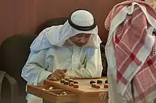 Image 22Two Qataris playing the traditional board game of damah (from Board game)