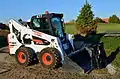 Bobcat skid steer loader with grapple bucket