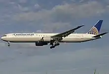 Twin-engine airliner with landing gear and flaps extended