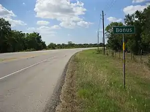 Bonus sign is on FM 102 north of the FM 2614 junction.