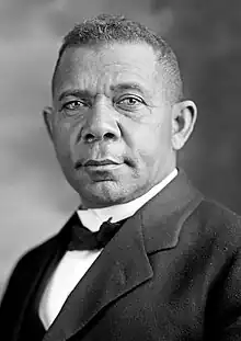 Black and white portrait of man wearing a suit, white dress shirt, and black bowtie