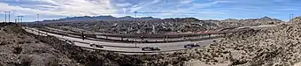 January 2019 construction progress. Note the new ramp behind the UTEP Miners' pickaxe sculpture. This ramp and elevated roadway will carry the westbound lanes of the new expressway; the eastbound lanes are at grade, on the far side of the train tracks.