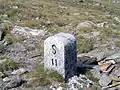 Border stone at Passo San Giacomo between Val Formazza [it] in Italy and Val Bedretto [it] in Switzerland