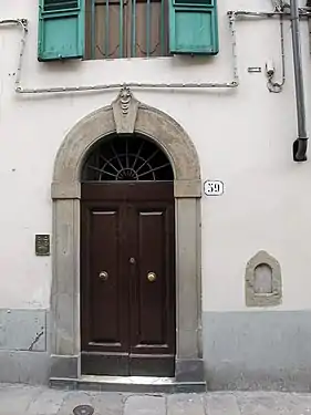 A blocked buchetta beside the entrance doors
