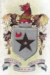 A silver shield with a black five-pointed star with a red crescent in the top left hand corner. Above the shield are the battlements of a tower surmounted by a red griffin's head. Below the shield is the motto "LABOR OMNIA VINCIT", which means "Persistent Works Triumphs".