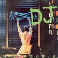 A man from the back grasping window blinds with the giant green letters "DJ" to the right.