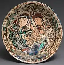 Persian mina'i ware bowl with couple in a garden, around 1200.  These wares are the first to use overglaze enamel decoration.