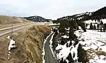 West portals of Bozeman Pass tunnels built by the Northern Pacific Railway. The original 1884 tunnel (abandoned) is on the right, while the newer 1945 tunnel is on the left (now used by Montana Rail Link).