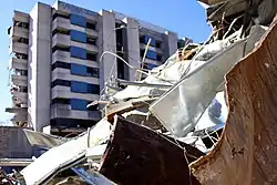 Debris in front of a partially demolished tower