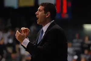 Stevens with his mouth open to shout, and his hands clapping.