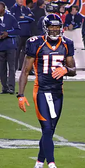 A football players looking towards his sideline.