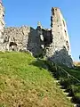 Wooden access stairs for tourists, leading into the ruins of the late 15th century annexe and the keep (July 2015)