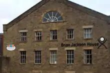 Large brown facade, with many windows