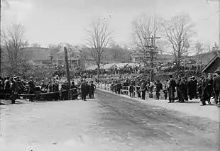 A large group of people observing a road race