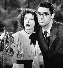 Katharine Hepburn and Cary Grant (in round glasses), looking off-screen