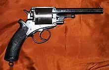 Long-barreled revolver with a black handle