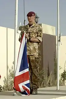 A British soldier of the Royal Artillery, with No.5: Desert Combat Dress shirt and trousers.