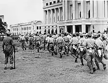 Japanese POWs are taken to work where they were made to clear up the city