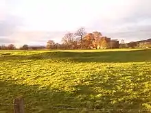 Image 34The banks of Brocavum Roman fort in the foreground; Brougham Castle is in the background (from History of Cumbria)