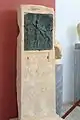 Bronze relief at votive stele Artemis with two satyrs preparing sacrofice, 225-200 BC.