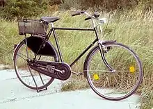 A Dutch utility bicycle with a rack attached over the rear wheel.