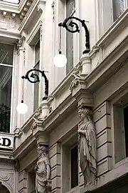 Hanging lamps and caryatids