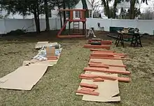 A playground being built for a homeowner's backyard as part of a handyman project