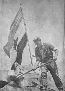 Photograph of a man digging with a shovel