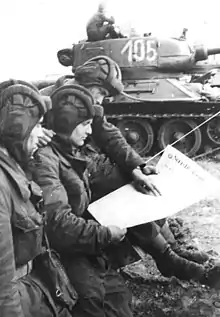 Image 40Soldiers in an East German tank unit reading about the erection of the Berlin Wall in 1961 in Neues Deutschland (from Newspaper)