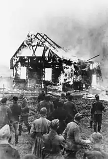 Image 54German soldiers and locals watch a Lithuanian synagogue burn in 1941. (from History of Lithuania)