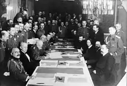 Black white photo of people sitting on a long table