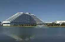 large white building with windows and water feature in front