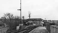 Railway station with two side platforms connected by footbridge