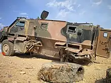 A Bushmaster IMV after encountering an IED; the drive train and utility bins were destroyed, but the hull is intact and the crew survived with only minor injuries.