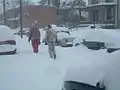 Two Columbus residents walk down Alden Avenue in Columbus due to the 3+ feet snowdrifts that covered the sidewalks.