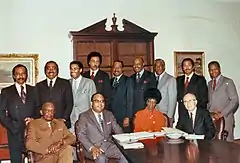 Rangel and twelve other African American members of Congress posed around a table