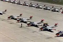 CT-114 Tutors belonging to 2 Canadian Forces Flying Training School parked on the ramp at CFB Moose Jaw, 1982