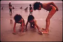 Children at a Brooklyn beach, 1974,  Danny Lyon