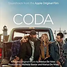 Four people sitting in a truck bed, with one staring at the camera; the word "CODA" appears above them