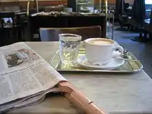 Image 20Coffee house culture between Vienna and Trieste: the coffee, the newspaper, the glass of water and the marble tabletop (from History of coffee)